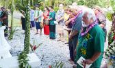 Utu Abe Malae's gravesite surrounded by people who attended his 1 year memorial service