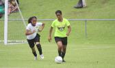 A Pago Youth defender, right, dribbles the ball out of danger against Utulei Youth