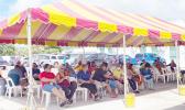 A crowd under a tent waiting to get vaccinated
