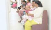 Mothers and babies wait at clinic