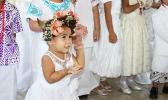 A little girl performing her White Sunday siva