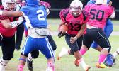 Faga’itua Vikings Leroy Fesili carrying this counter hand off towards the middle of the Sharks defense, steadily following two of his blockers double teaming Vimoto Mageo – in the opening quarter of their Varsity game last Friday evening. Samoana defeated the Vikings 24 - 22. [photo: TG]