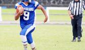 Samoana quarterback Anthony Feala, storming through mid-field as he checks for nearby defenders – in the second half of their JV game last Saturday morning. Feala led the Sharks in their 18 - 0 win against Nu’uuli, as their final game of the season.  [photo: TG]