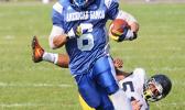 Louis Malala Jr., the strongest workhorse at Samoana’s backfield, looking towards the goal line after breaking a tackle from Uriah Te’o, in the opening half of their JV game last Saturday morning at the Veterans Memorial Stadium. Malala helped Samoana in their 36 - 20 victory.