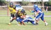 Fred Meredith of the Wildcats gets brought down by Samoana’s Fa’au Seumanutafa. The play caused a fumble in the opening quarter of their varsity game last Friday evening. Samoana beat the Wildcats 13 - 6, winning their first victory of the season.  [photo: TG]