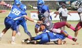 Pete Fa’avae of the Warriors taken down there by Samoana’s Cornelius Aiava, in the opening half of their varsity game last Saturday morning. The Warriors defeated the Sharks 28 - 12. [photo: TG]