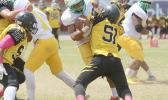 Leone Lions Luteru Ah Loe gets tackled hard there by Branson Pualau of Nu’uuli during their varsity match last Saturday. They tied 20 - 20 as of results. [photo: TG]