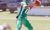 Leone Lions quarterback Ronnie Maae attempts a pass in the second quarter of their varsity match up against the Sharks last Saturday – Leone lost 6 - 0 to the Sharks. [photo: TG]