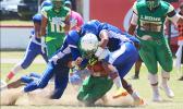 David Mikaele and Vimoto Mageo sandwich tackle Leone Lions running back Luteru Ah Loe, in the opening half of their varsity rivalry game last Saturday – Samoana won over the Lions 6 - 0. [photo: TG]