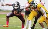 Jr. Sufia of the Warriors trying to break this tackle, as he is one of the most explosive skill players for Tafuna to field this year. Sufia helped the Warriors in their 38- point victory over Leone. [photo: TG]