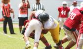 Heini Ta’ase getting hammered in the backfield for a loss by Uriah Te’o of Nu’uuli, as he didn’t fall for the option give this time – in the second quarter of the JV match last Saturday. Faga’itua won 28 - 8. [photo: TG]