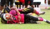 John Muliaga of Faga’itua watches the live ball helplessly after being rocked hard by Branson Pualau in the second quarter of the match – causing a fumble that carried Nu’uuli into Vikings territory for another threatening offensive drive.  [photo: TG]