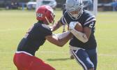 Samoana Sharks wide receiver Avery Seumanutafa trying to escape a tackle by Fitu Amata