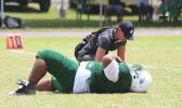 Florence Wasko tending to one of the many injured in Saturday's games, this time it is Cyan Fiatoa